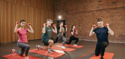 Indoor group workout session with dumbbells focusing on strength and fitness.